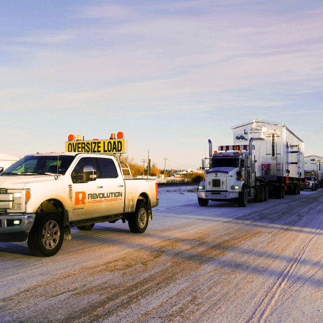 Revolution Crane & Transport - Work truck escorting two transport trucks to site